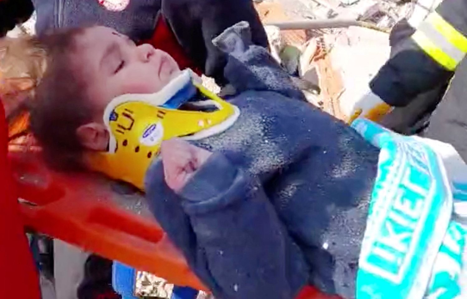 A child is rescued from the rubble Feb. 12, 2023, after 150 hours in the aftermath of an earthquake in Hatay, Turkey, in this screen grab taken from a handout video. The powerful 7.8 magnitude earthquake rocked areas of Turkey and Syria early Feb. 6, toppling hundreds of buildings and killing tens of thousands. (OSV News photo/Turkish Health Ministry handout via Reuters)